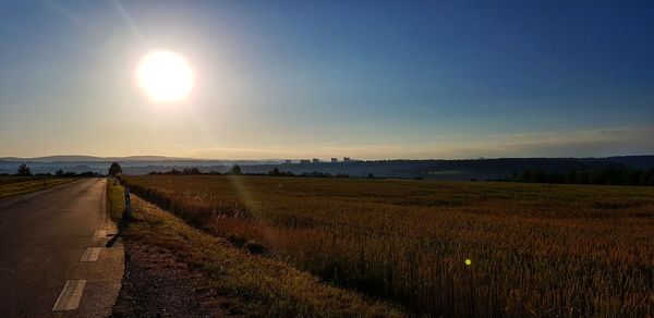 Scenic view of field against sky during sunset