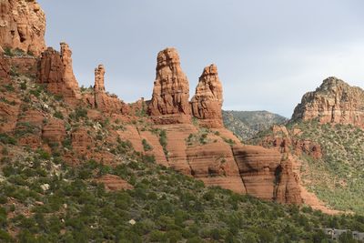 Rock formations at temple against sky