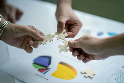 High angle view of couple holding hands on table