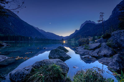 Panoramic view of lake and mountains against sky at dusk