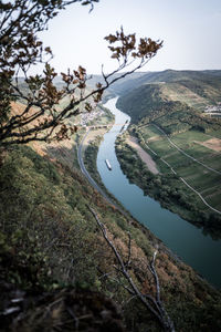 High angle view of river amidst trees against sky