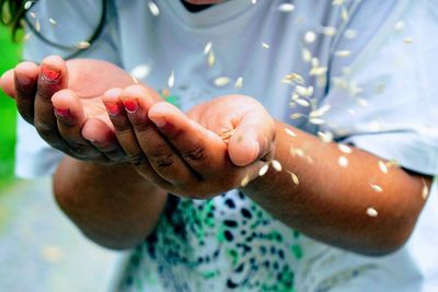 Close-up of girl with seeds in her hand