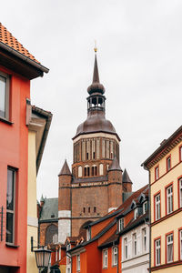 Traditional colorful houses and church tower in the old town of stralsund.