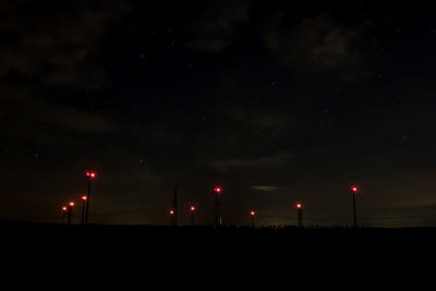 Illuminated lights against sky at night