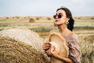 Young woman wearing sunglasses on field