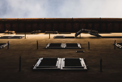 Chairs and tables in building against sky