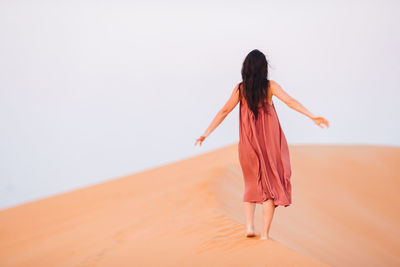 Rear view of woman standing on beach