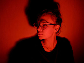 Cute girl with glasses under red light