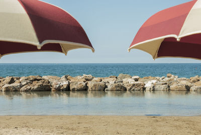 Beach umbrellas against clear sky