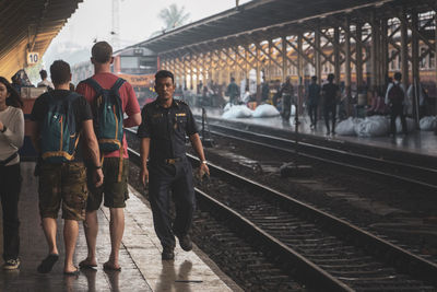 People waiting at railroad station platform