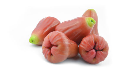 Close-up of fruits over white background