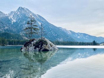 Scenic view of lake and mountains against sky