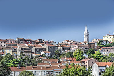 High angle view of bell tower in town against clear sky