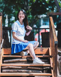 Smiling young woman sitting on steps