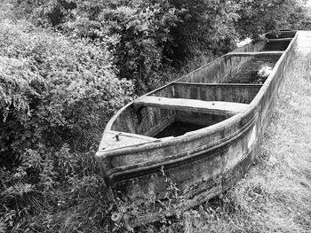 Abandoned boat moored on land