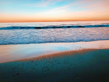 Scenic view of beach against sky during sunset