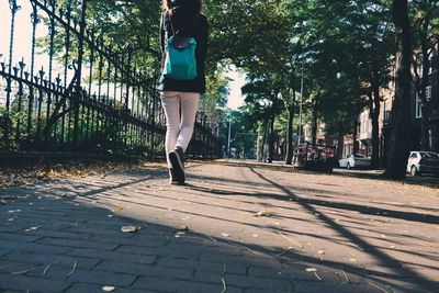 Low section of woman on tree against sky