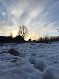 Snow covered field against sky