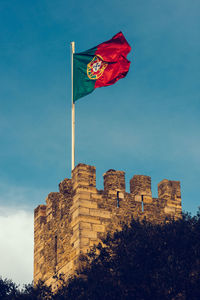 Portuguese flag at the old castle castelo sao jorge in lisbon, portugal