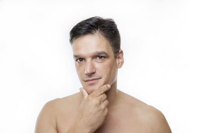 Portrait of shirtless man against white background