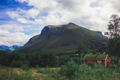 Scenic view of mountains and houses against sky