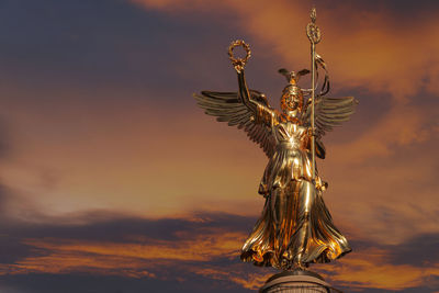 Low angle view of statue against sky during sunset