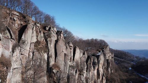 Low angle view of rock formation against sky