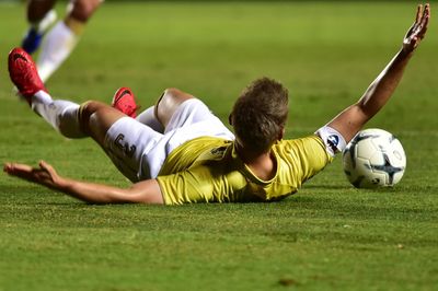 People playing soccer ball on field