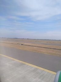 Scenic view of airport runway against sky