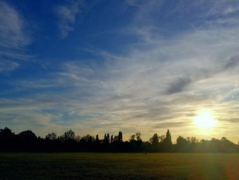 Scenic view of field against sky during sunset