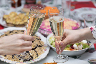 Midsection of woman holding ice cream on table