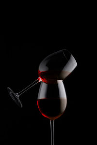 Close-up of wineglass against black background