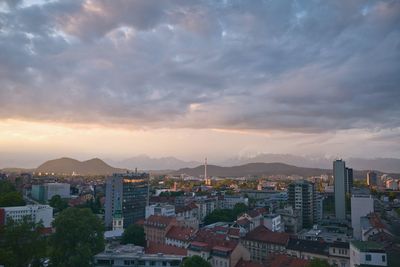 Cityscape against cloudy sky