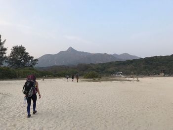 Full length of man on beach against clear sky