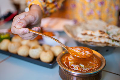 Midsection of woman preparing food