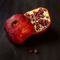 High angle view of fruits on table against black background