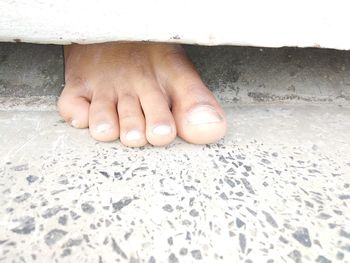 Close-up of hands on sand