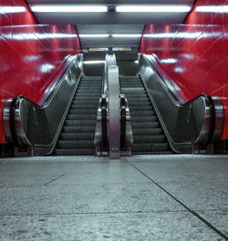 Rear view of people on escalator at subway station