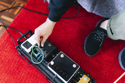 Male composer adjusting musical instrument at studio