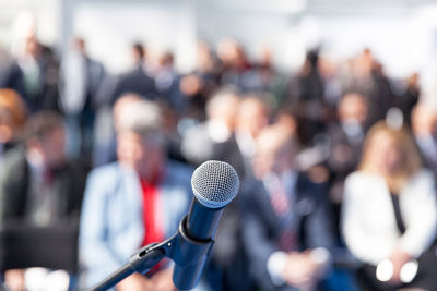 Close-up of microphone against crowd during event