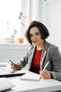 Portrait of young confident businesswoman in modern office. woman-owned business,