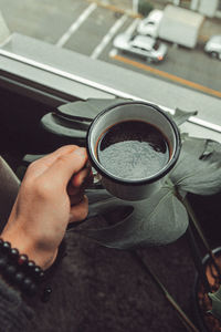 Midsection of person holding coffee cup