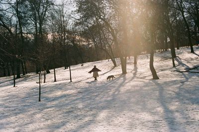 People walking on snow covered landscape