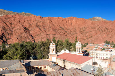 Exterior of houses in town with mountains in background