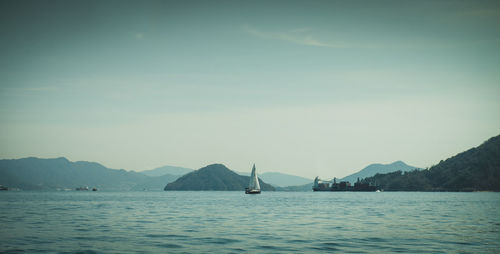 Sailboat in sea against sky