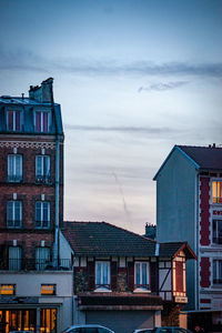 Low angle view of buildings in town against sky