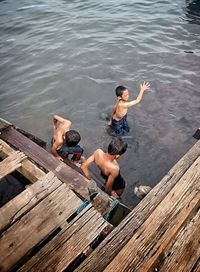 High angle view of boy playing in lake