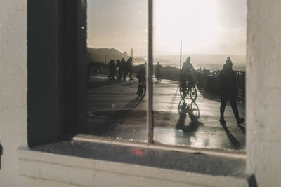 Silhouette people walking on street