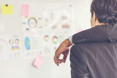 Rear view of businessman working in office