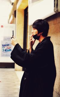 Side view of man using mobile phone